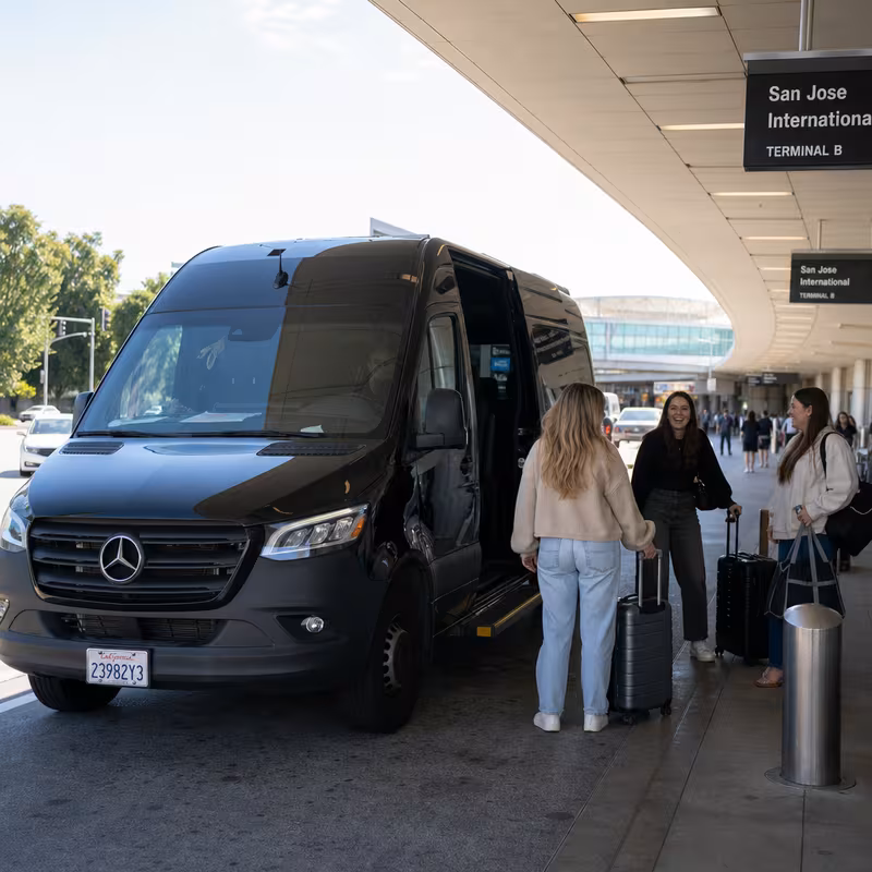 Group boarding a white charter bus for Airport Transportation transportation in San Jose