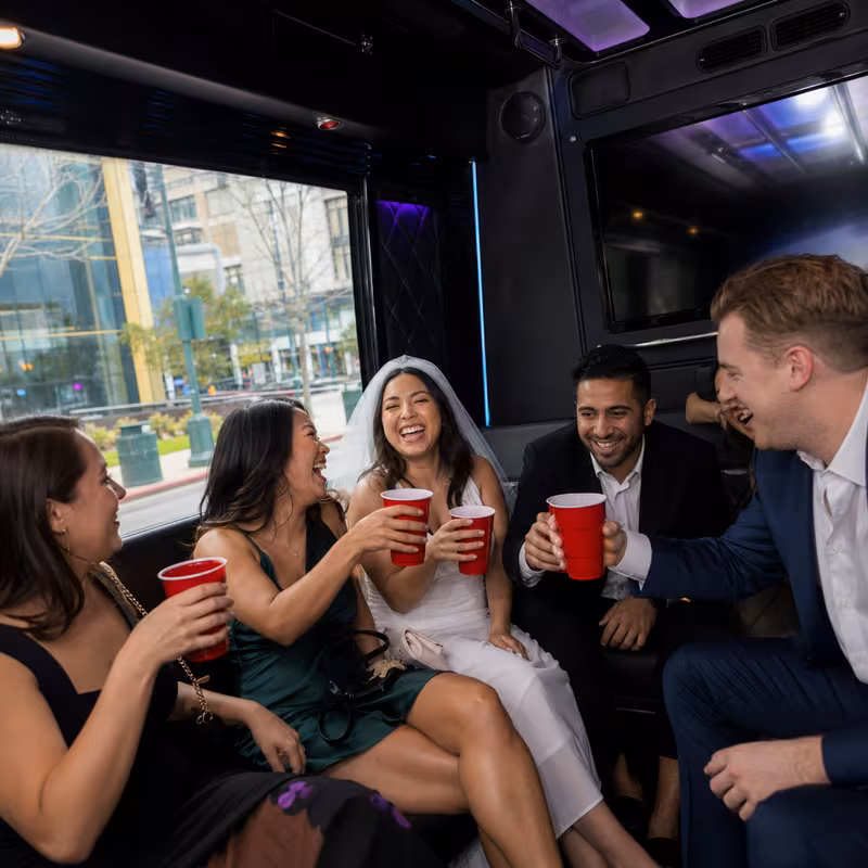 Party bus interior with wraparound leather seating and LED lighting in San Jose