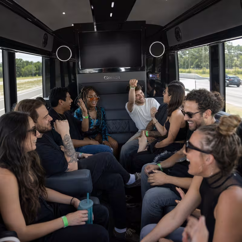 Group boarding a white charter bus for Concert Transportation transportation in San Jose