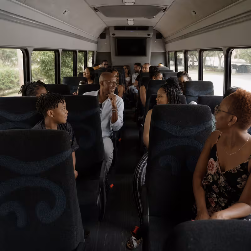 Group boarding a white charter bus for Private Event Transportation transportation in San Jose