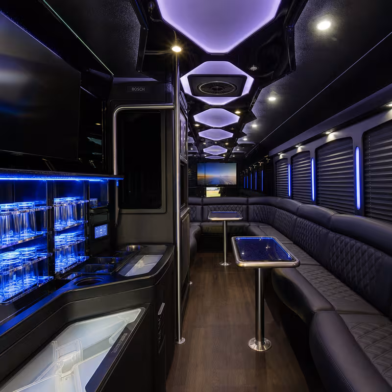 Party bus interior with wraparound leather seating and LED lighting in San Jose