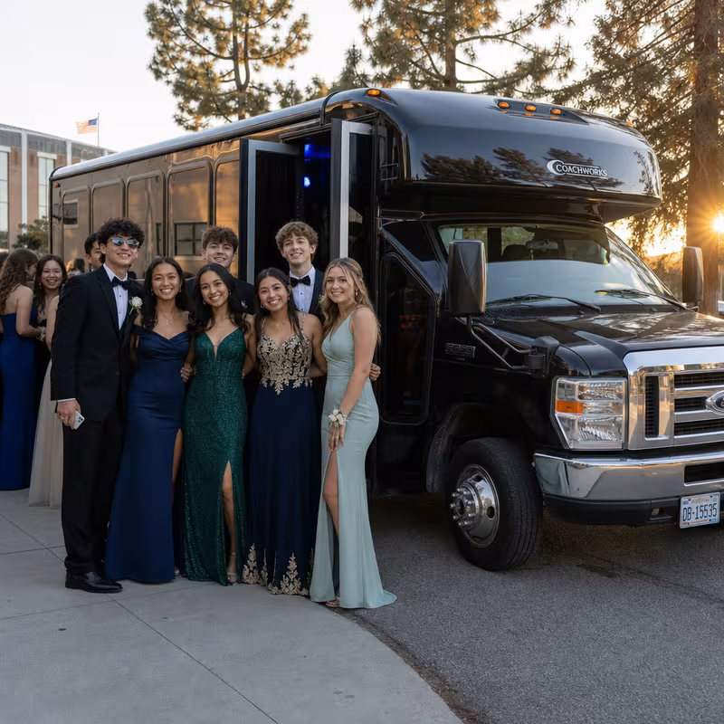 Group boarding a white charter bus for Prom & Homecoming Transportation transportation in San Jose