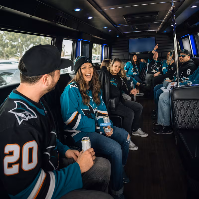 Group boarding a white charter bus for Sporting Event Transportation transportation in San Jose