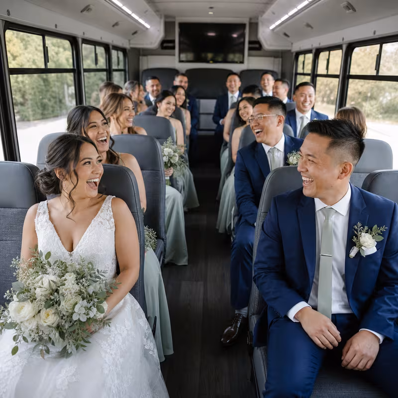 Group boarding a white charter bus for Wedding Transportation transportation in San Jose