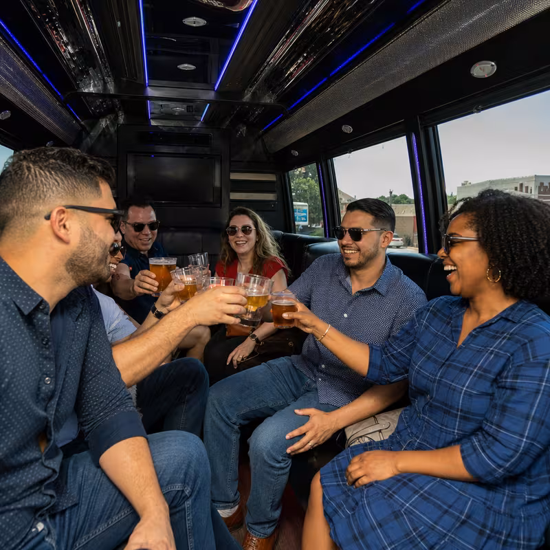 Group boarding a white charter bus for Winery & Brewery Tour Transportation transportation in San Jose