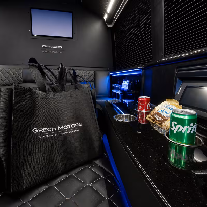 Party bus interior with wraparound leather seating and LED lighting in San Jose